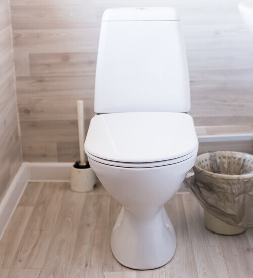 a toilet in a wooden bathroom